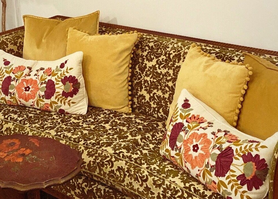 Floral-embroidered sofa at All The Things Salon and Wellness in Fort Myers, Florida, US for a chic and cozy ambiance.