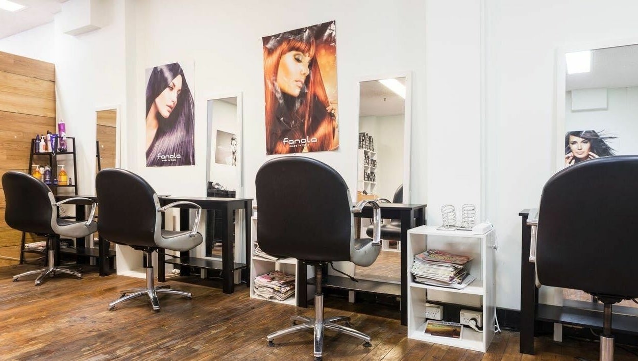 Modern styling stations at Eton Place of Hairdressing, Sydney, New South Wales, AU, featuring sleek chairs and mirrors.