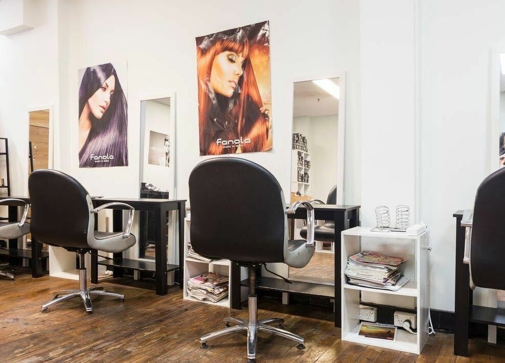 Modern styling stations at Eton Place of Hairdressing, Sydney, New South Wales, AU, featuring sleek chairs and mirrors.