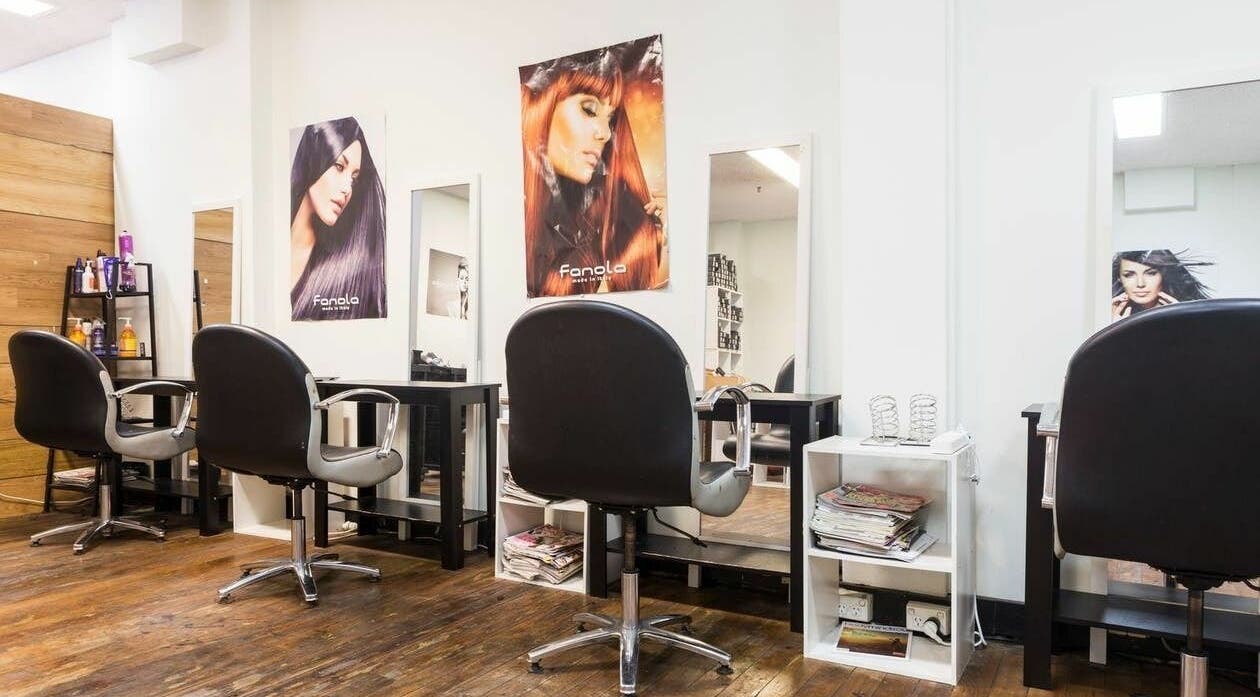 Modern styling stations at Eton Place of Hairdressing, Sydney, New South Wales, AU, featuring sleek chairs and mirrors.