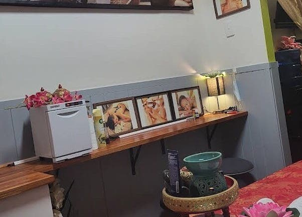 Tranquil spa room at Beyonder Relax and Wellness, Paradise Point, Queensland, AU, featuring cozy decor and artworks.