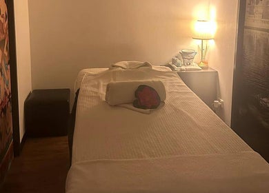 Tranquil massage room at Youi Thai Massage, New Farm, Queensland, AU, featuring cozy lighting and decor.