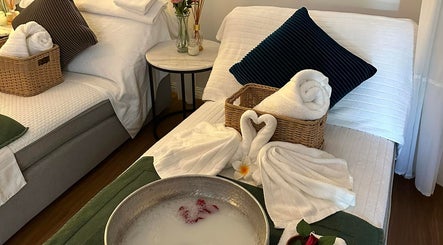 Relaxing massage beds at Youi Thai Massage in New Farm, Queensland, AU with towels and floral decor.