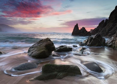 Sunlit rocky shore at Ki Health and Wellness, Whitby, Ontario, CA, offering a serene coastal retreat.