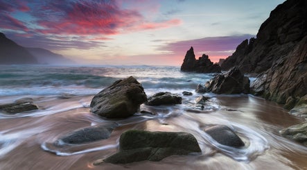 Sunlit rocky shore at Ki Health and Wellness, Whitby, Ontario, CA, offering a serene coastal retreat.