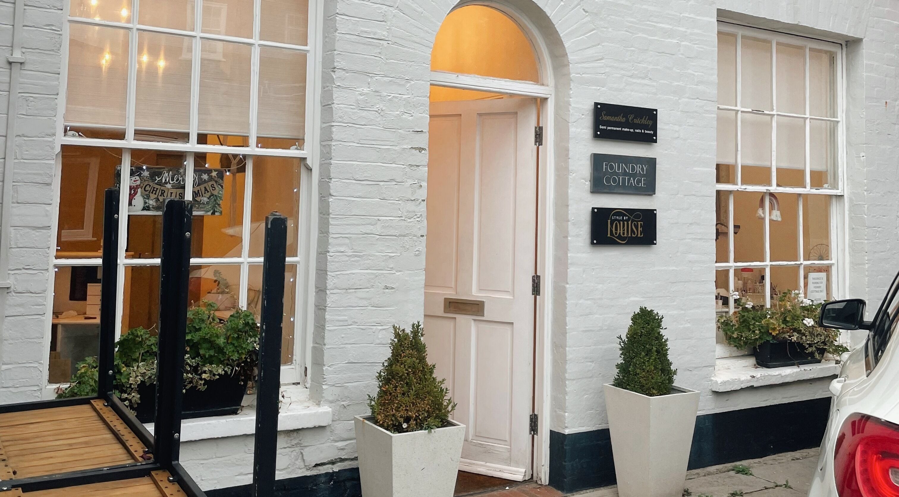 Exterior view of Face Co Beauty and Aesthetics in Taunton, England, GB with festive decor and welcoming entrance.