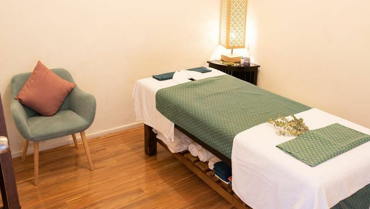 Tranquil massage room at The Massage Studio in Melbourne, Victoria, AU, featuring a cozy chair and prepared massage table.