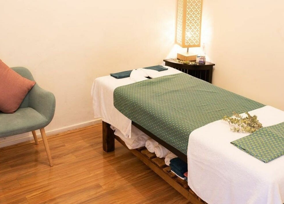 Tranquil massage room at The Massage Studio in Melbourne, Victoria, AU, featuring a cozy chair and prepared massage table.