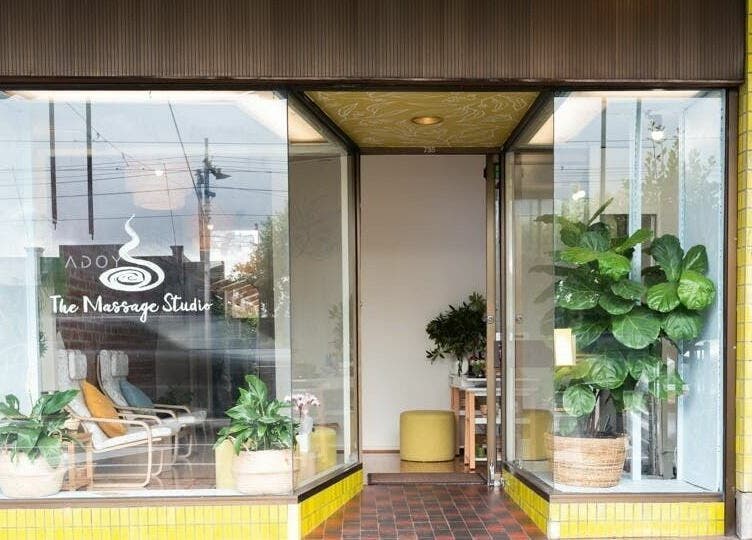 Inviting entrance of The Massage Studio in Melbourne, Victoria, AU with lush plants and cozy chairs.