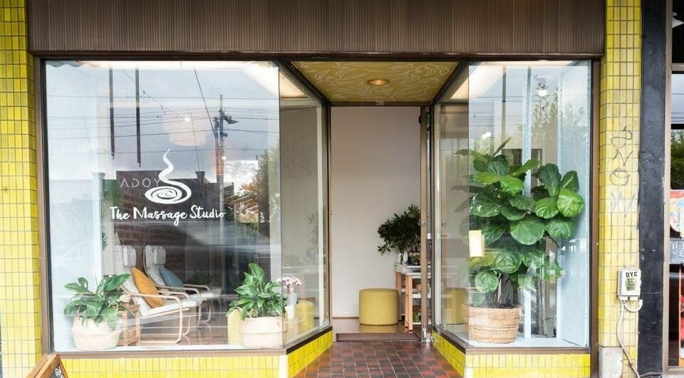 Inviting entrance of The Massage Studio in Melbourne, Victoria, AU with lush plants and cozy chairs.