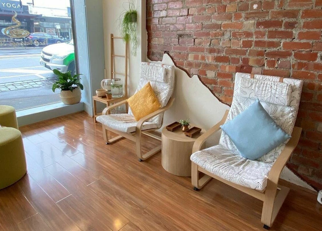 Cozy seating area at The Massage Studio, Melbourne, Victoria, AU, featuring comfy chairs and natural decor.