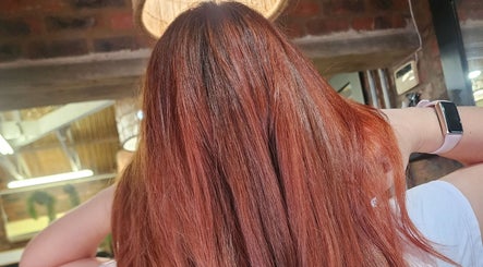 Silky copper hair styled at Mariska J Hairstylist, Pretoria, Gauteng, ZA, gleaming under salon lights.
