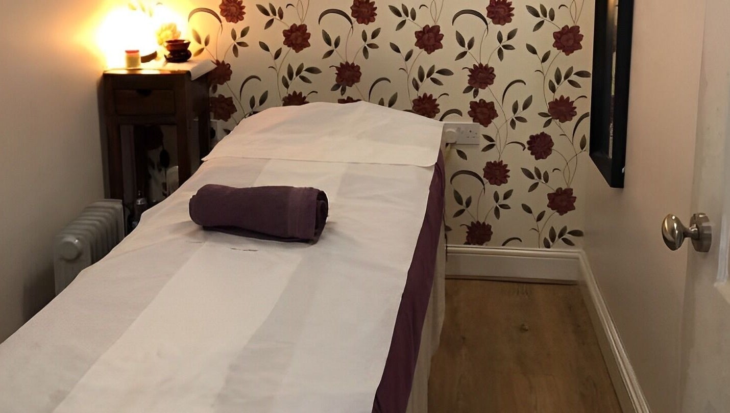 Relaxing therapy room at Dee Therapy & Salon, Harrow, England, GB, with a floral backdrop.