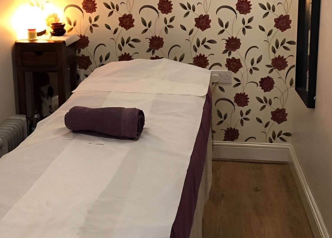 Relaxing therapy room at Dee Therapy & Salon, Harrow, England, GB, with a floral backdrop.