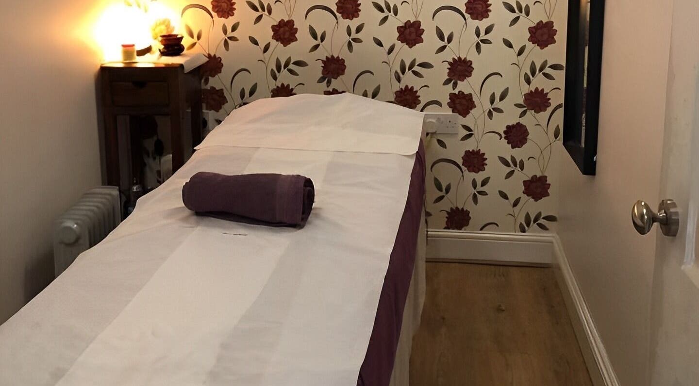 Relaxing therapy room at Dee Therapy & Salon, Harrow, England, GB, with a floral backdrop.