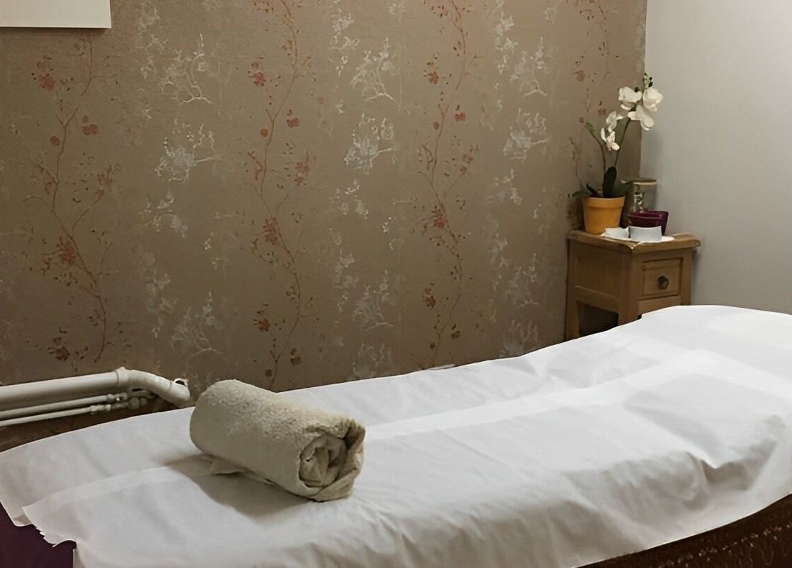 Relaxing massage room at Dee Therapy & Salon, Harrow, England, GB, with soft lighting and subtle decor.
