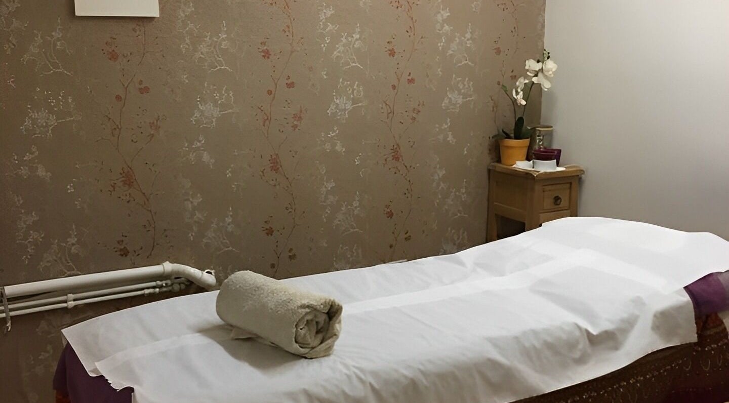 Relaxing massage room at Dee Therapy & Salon, Harrow, England, GB, with soft lighting and subtle decor.