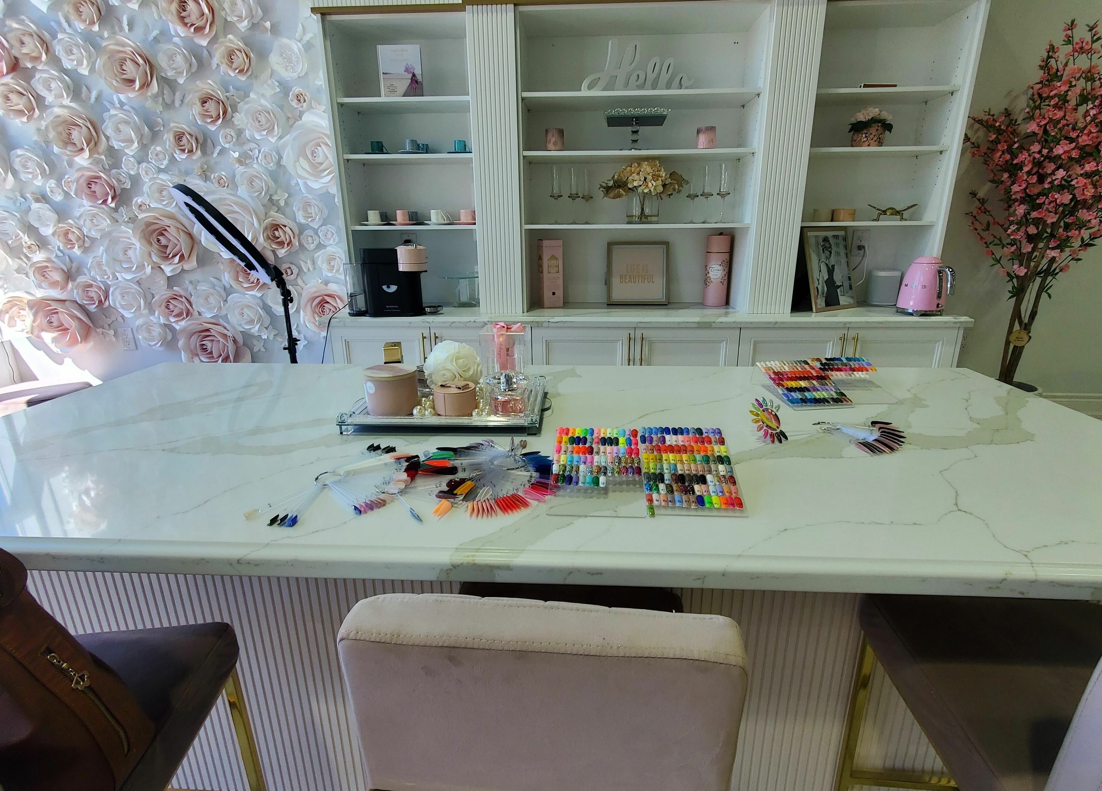 Nail design table at Nails a More Woodbridge with floral decor in Vaughan, Ontario, CA.