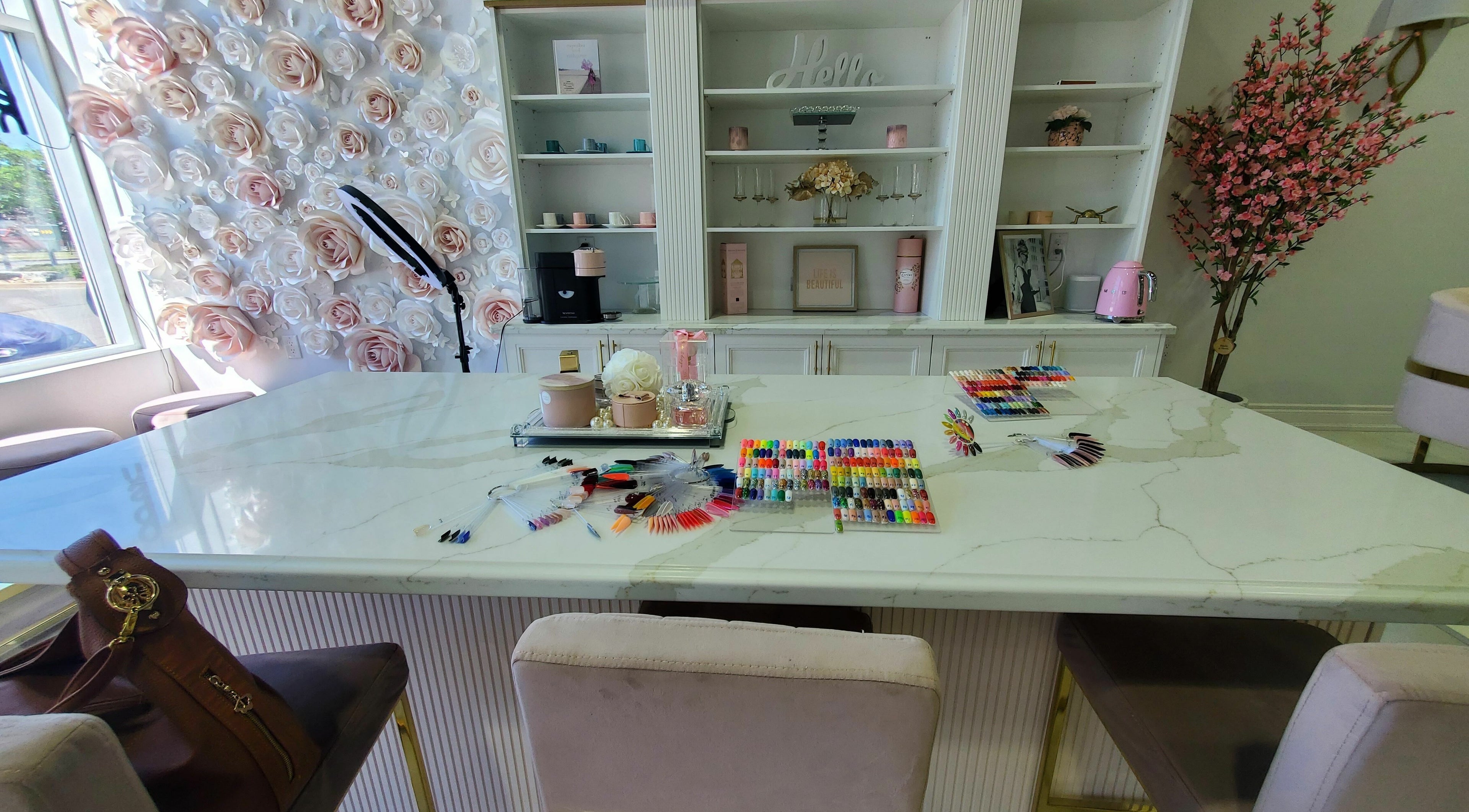 Nail design table at Nails a More Woodbridge with floral decor in Vaughan, Ontario, CA.
