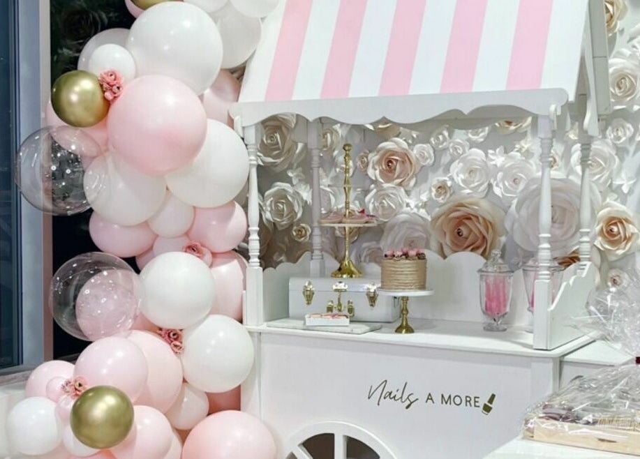 Elegant celebration cart at Nails a More Woodbridge, Vaughan, Ontario, CA adorned with balloons and floral decor.