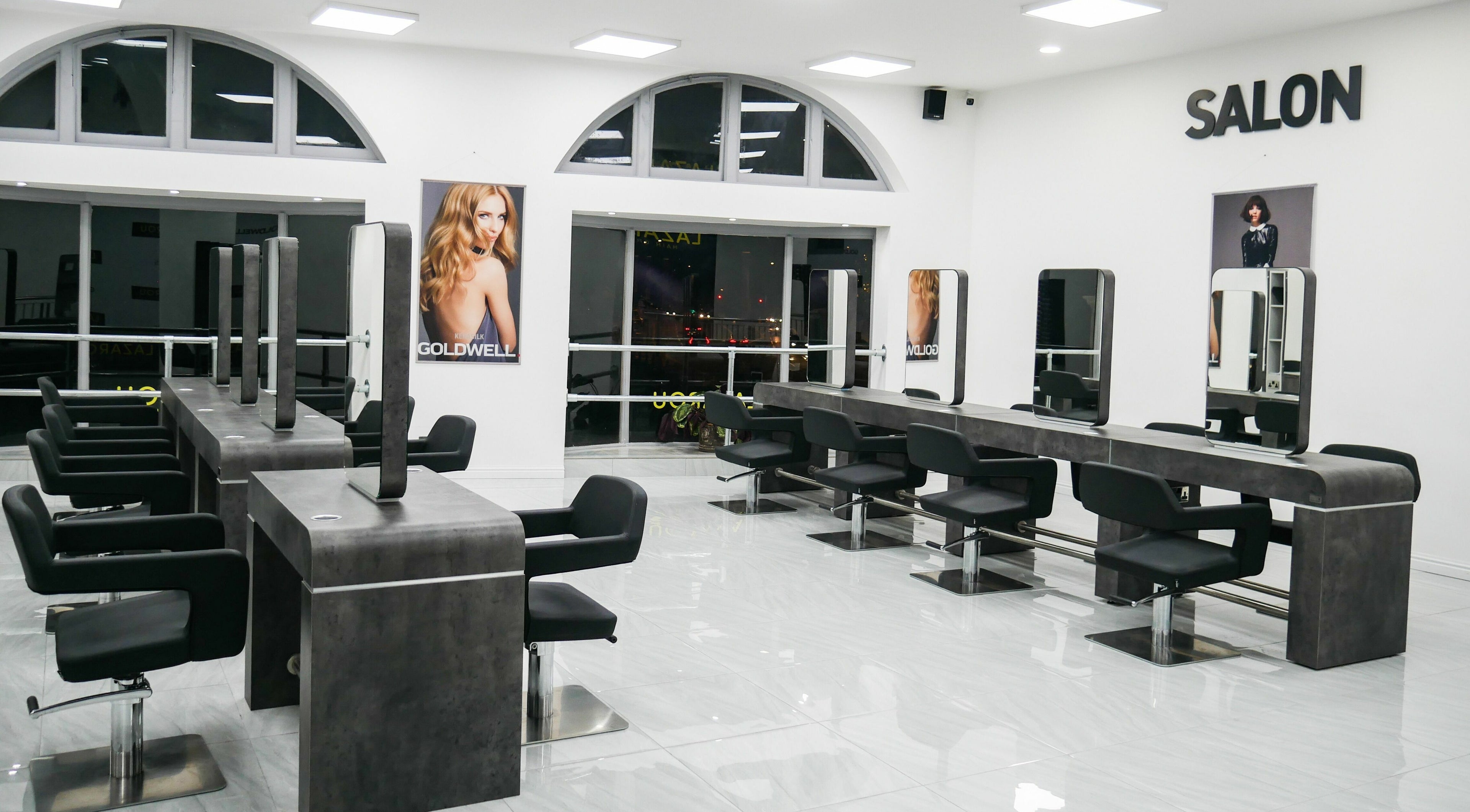 Modern interior of Lazarou Cardiff Castle Hair Salon featuring sleek chairs and mirrors in Cardiff, Wales, GB.
