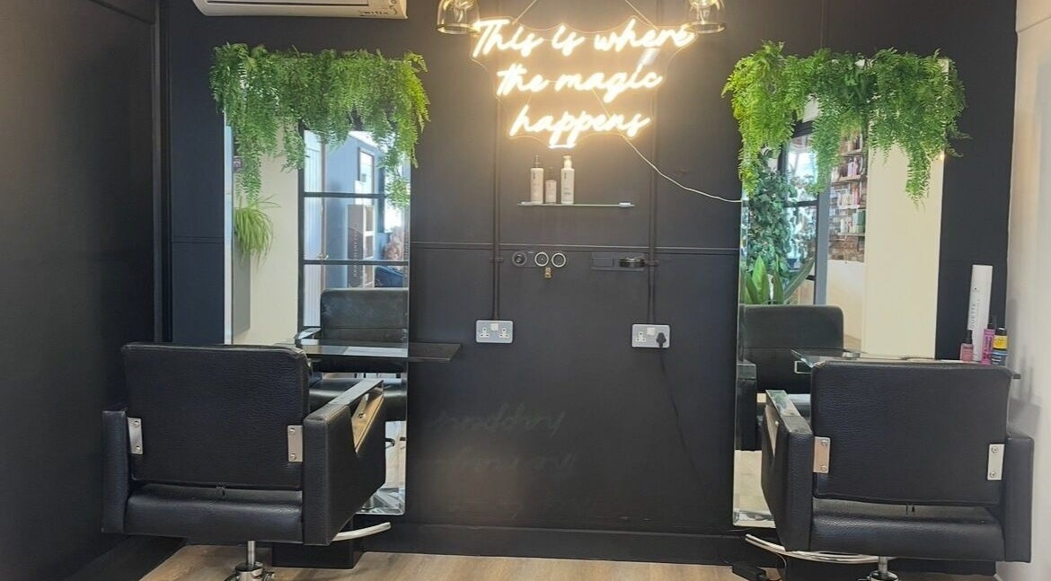 Elegant salon chair under neon sign at THE GLOSS, Lowestoft, England, GB.