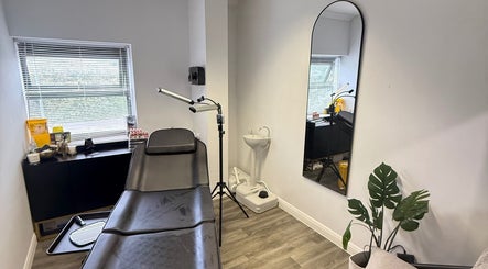 Modern treatment room at Tweak Clinic, Peterborough, England, GB, featuring sleek decor and comfortable seating.