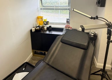 Cozy treatment room at Tweak Clinic, Peterborough, England, GB, featuring a reclining chair and ambient lighting.