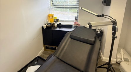 Cozy treatment room at Tweak Clinic, Peterborough, England, GB, featuring a reclining chair and ambient lighting.
