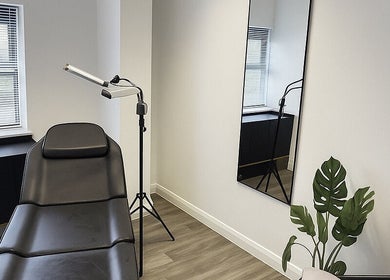 Modern treatment room at Tweak Clinic in Peterborough, England, GB, featuring sleek furniture and vibrant decor.