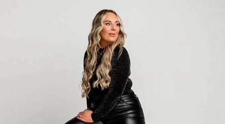 Person seated at Apricot Road Luxury Spray Tanning, Eglinton, Western Australia, showcasing sleek fashion.