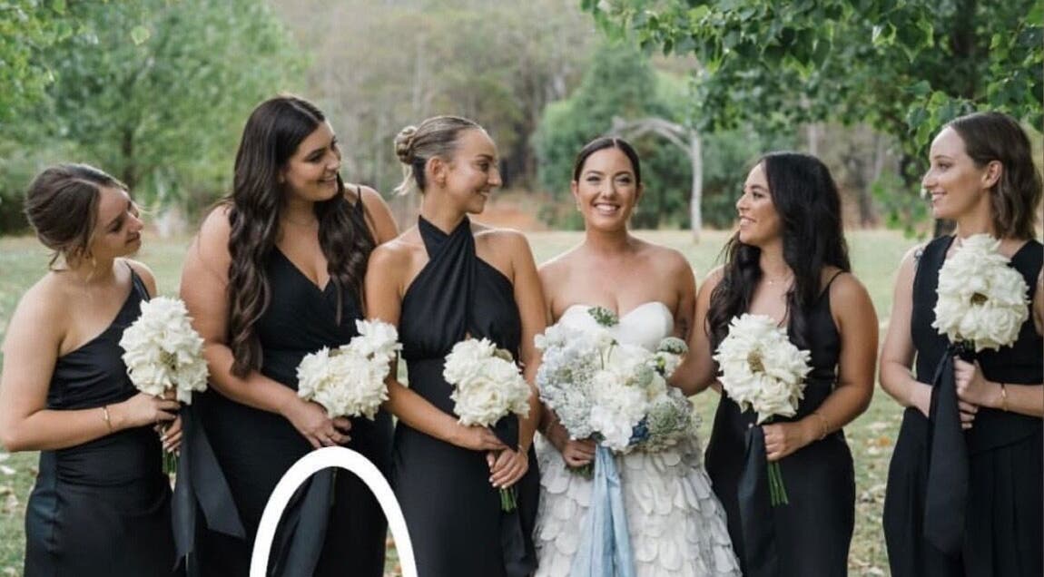 Bridal party in elegant black dresses with bouquets at Apricot Road Luxury Spray Tanning, Eglinton, Western Australia, AU.