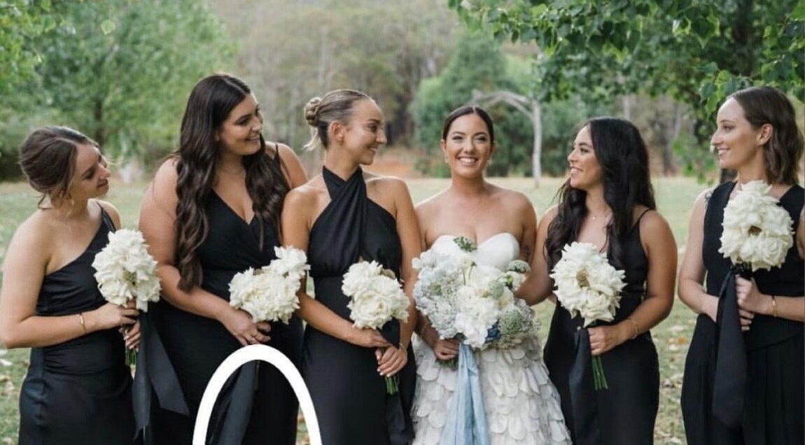 Bridal party in elegant black dresses with bouquets at Apricot Road Luxury Spray Tanning, Eglinton, Western Australia, AU.