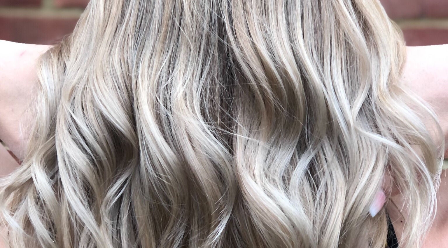 Stylish wavy blonde hair at Hair by Lois, Ramsey, England, GB. Expert styling for a glamorous look.