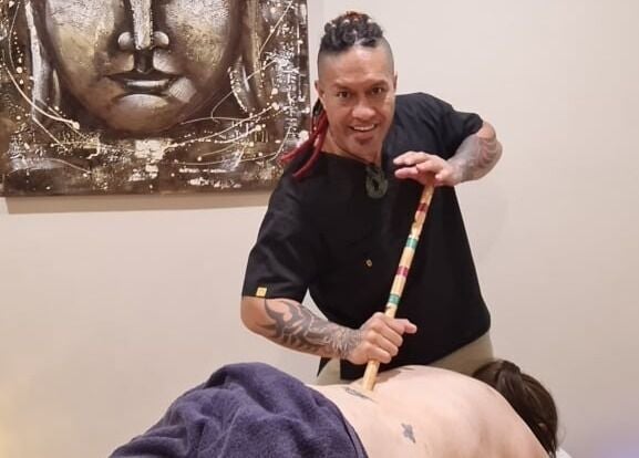 Therapist at Mana Physiques, South Toowoomba, Queensland, AU, performing a bamboo massage.