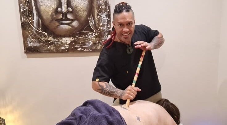 Therapist at Mana Physiques, South Toowoomba, Queensland, AU, performing a bamboo massage.