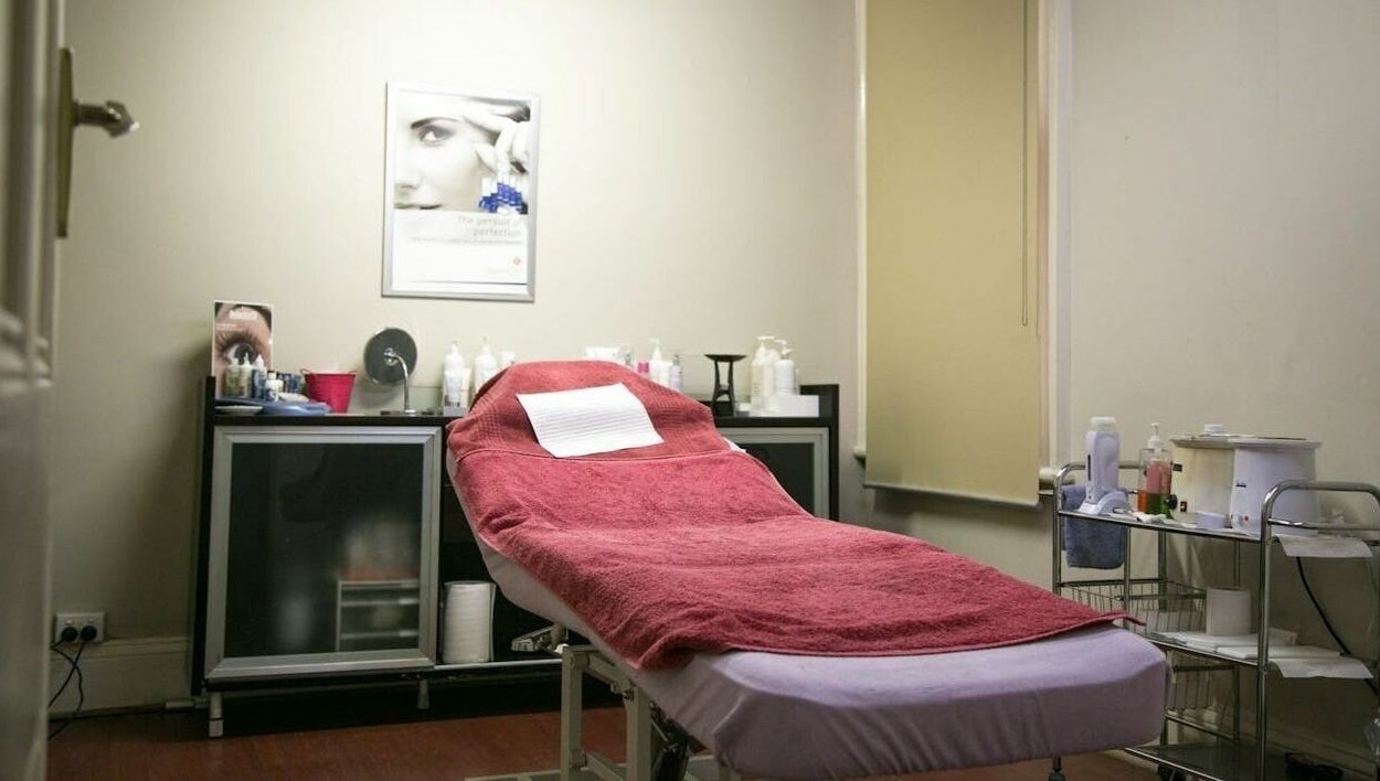 Cozy treatment room at Carpe Diem Studio, Melbourne, Victoria, AU with a red-towel massage table.