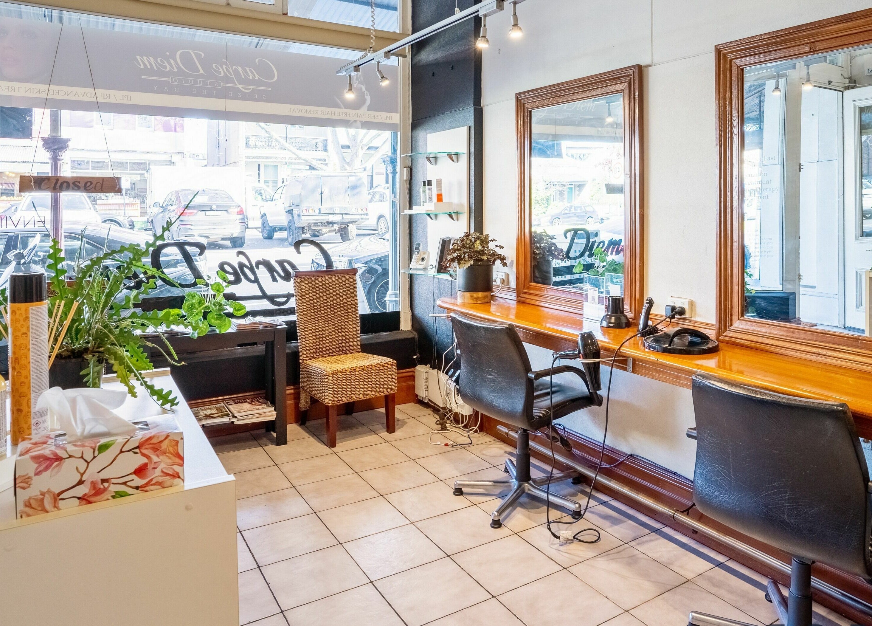 Cozy interior of Carpe Diem Studio in Melbourne, Victoria showcasing styling stations and elegant decor.