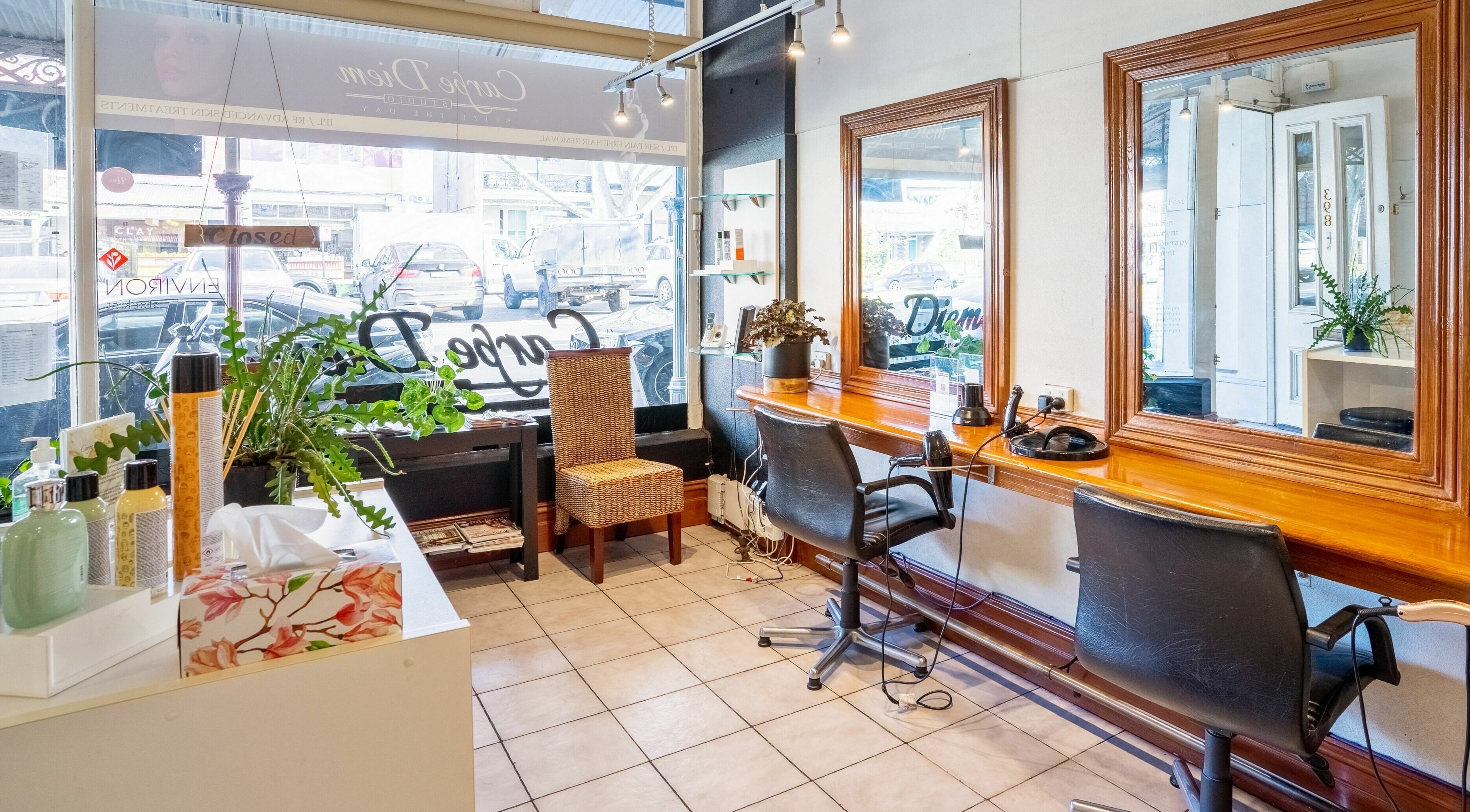 Cozy interior of Carpe Diem Studio in Melbourne, Victoria showcasing styling stations and elegant decor.