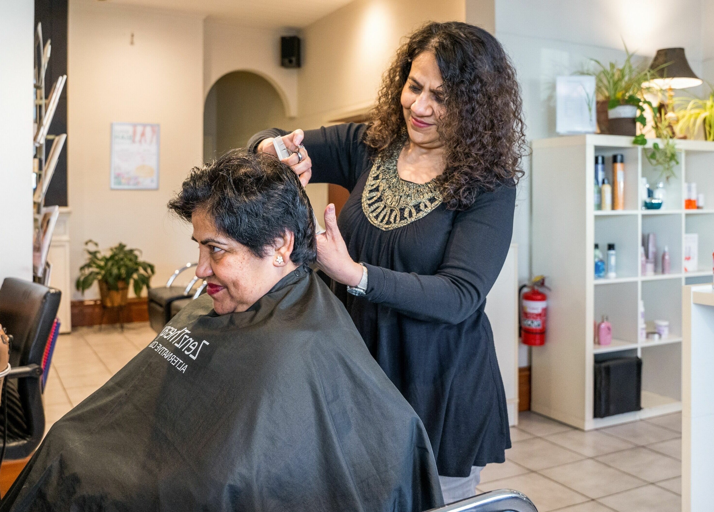 Stylist at Carpe Diem Studio in Melbourne giving a client a haircut in a bright, welcoming salon.
