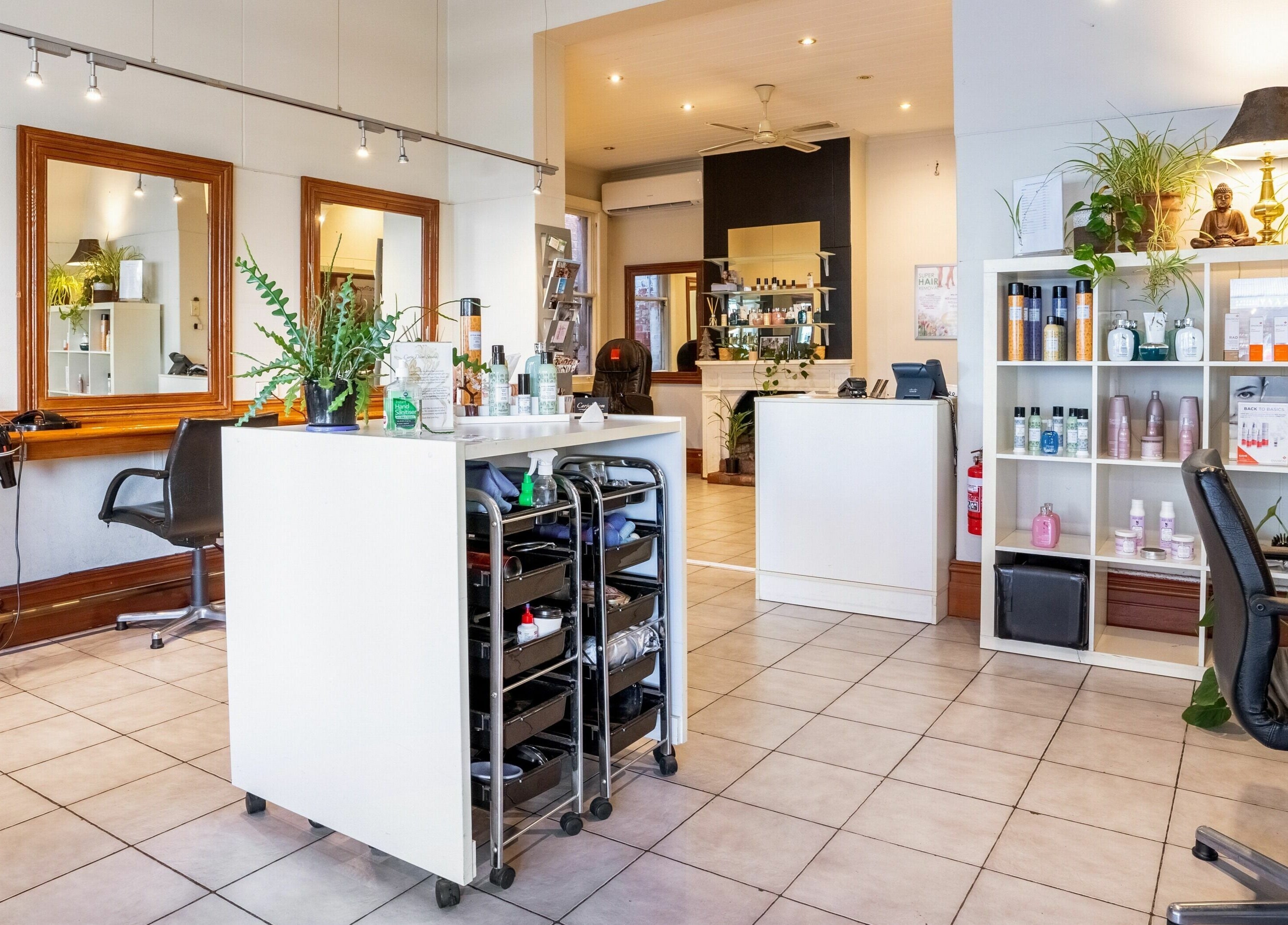 Interior of Carpe Diem Studio, Melbourne, Victoria, AU, showcasing styling stations and product shelves.