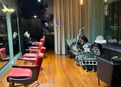 Interior of Mayhem Melbourne (Barbers) featuring red chairs and motorcycle decor in Melbourne, Victoria, AU.