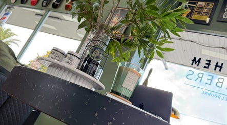 Stylish decor at Mayhem Melbourne (Barbers), Melbourne, Victoria, AU featuring candles and plants.