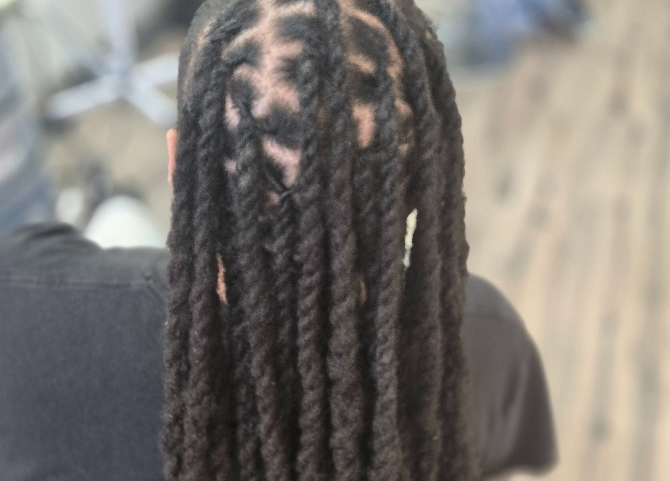 Beautifully styled locs at Naturally Loc'd by Ci in Charlotte, North Carolina, US.