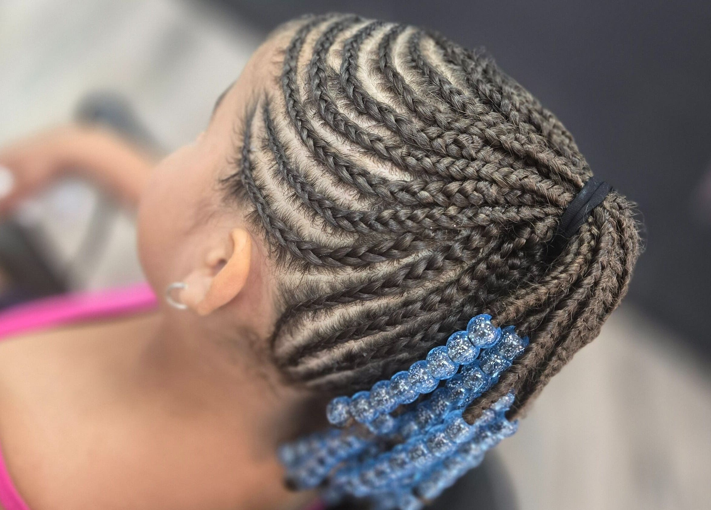Intricate cornrow braids with blue beads at Naturally Loc'd by Ci, Charlotte, North Carolina, US.