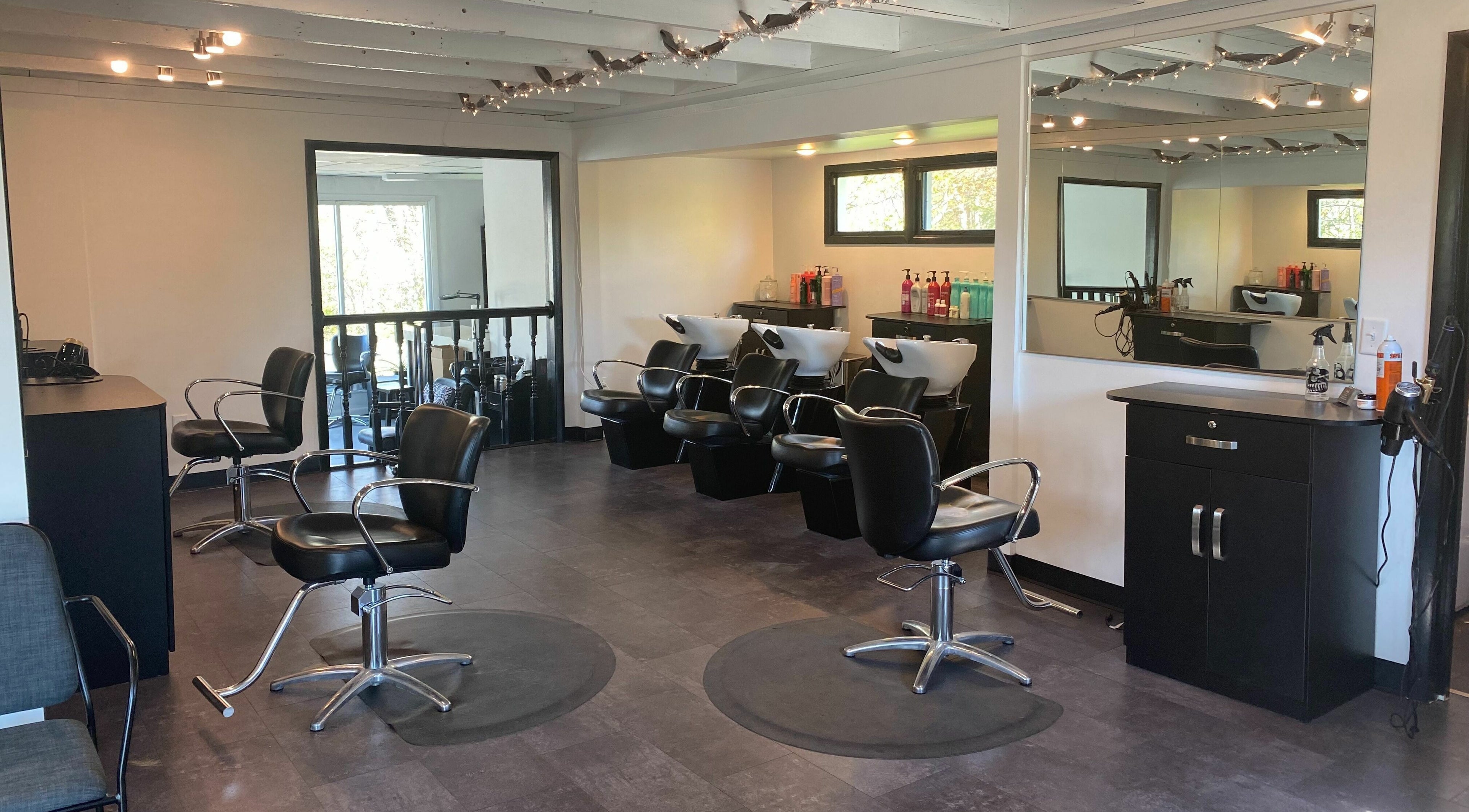 Stylish salon interior at Vertical Hair and Supplies, LLC, Derby, New York, US with modern chairs and wash stations.