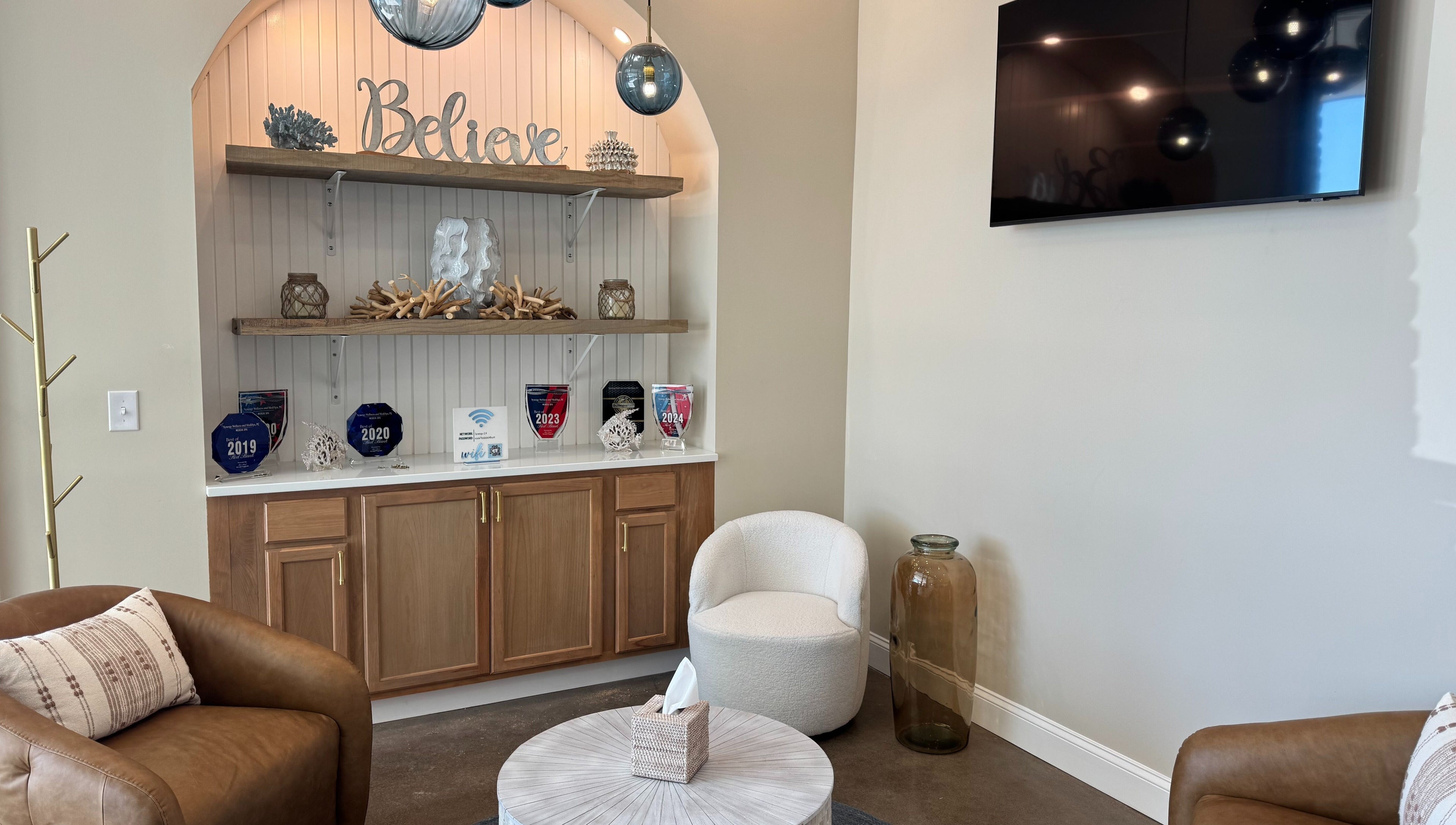 Inviting lounge area at Synergy Wellness and MediSpa in Oceanport, New Jersey, US with elegant decor and comfy seating.