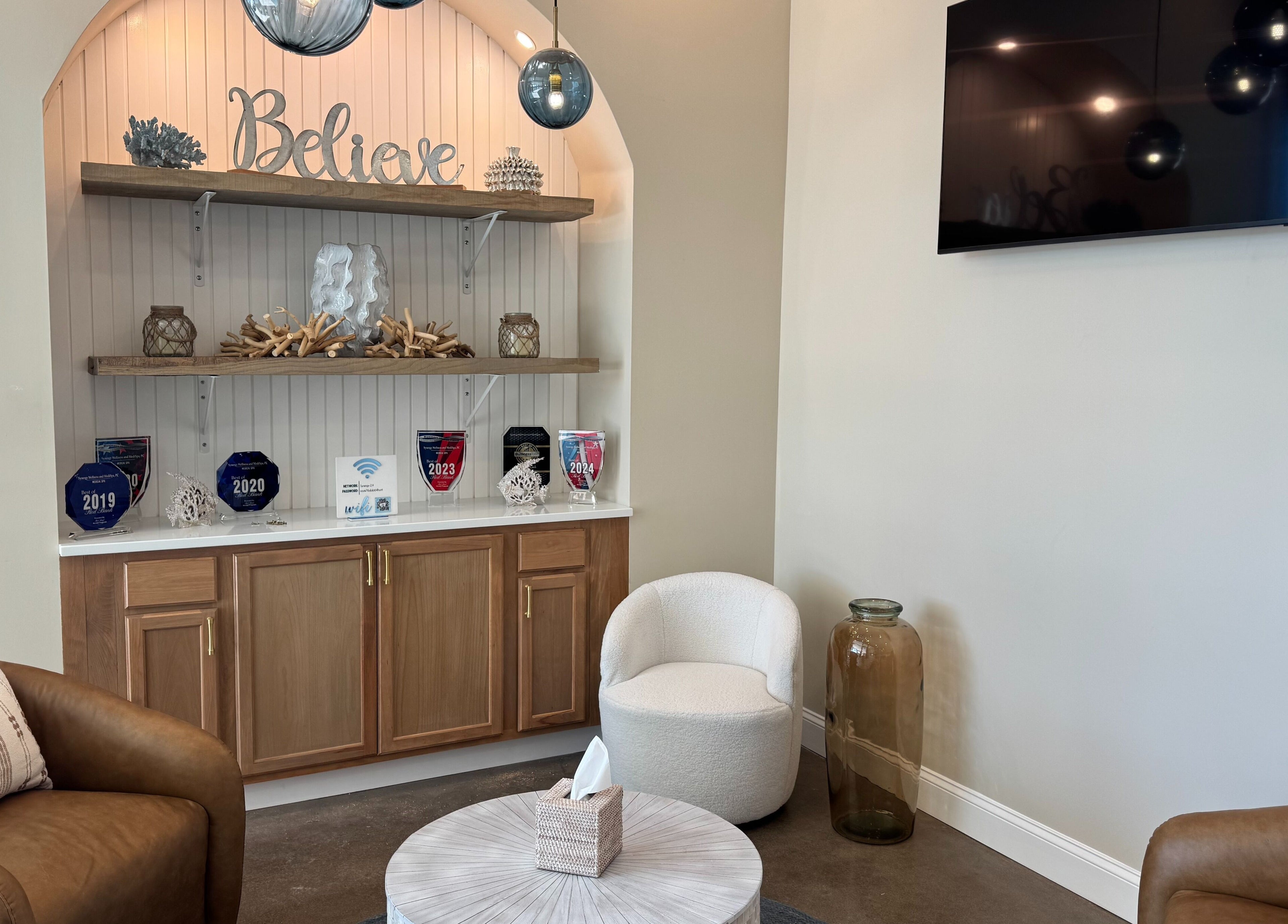 Inviting lounge area at Synergy Wellness and MediSpa in Oceanport, New Jersey, US with elegant decor and comfy seating.