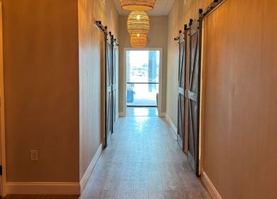 Elegant rustic hallway at Synergy Wellness and MediSpa, Oceanport, New Jersey, US, with warm lighting.
