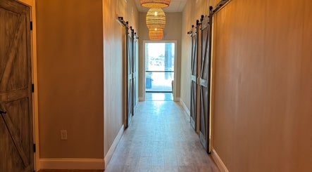 Elegant rustic hallway at Synergy Wellness and MediSpa, Oceanport, New Jersey, US, with warm lighting.